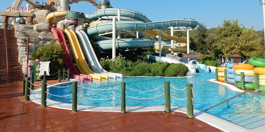 A lively scene at Aqua Fantasy water park showcasing colorful slides and attractions