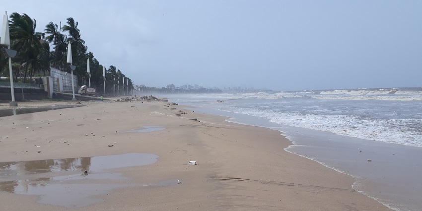 A view of Arnala Island surrounded by the sea, featuring greenery and a coastline.