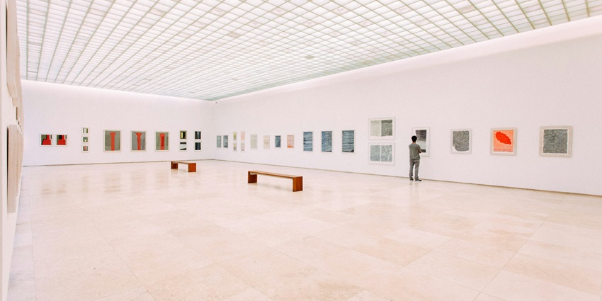 An inside view of a famous tourist attraction featuring paintings of renowned artists.