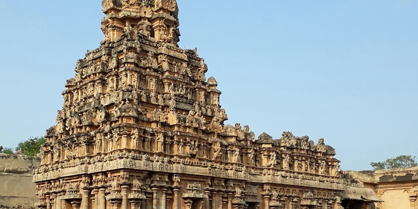 A facade of a Hindu temple adorned with intricate carvings and vibrant colours
