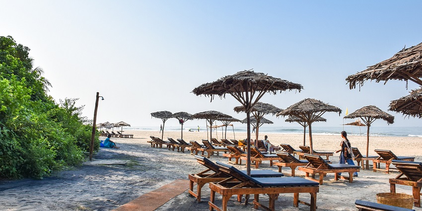 A picture of a beach in Goa with numerous shacks in the surroundings