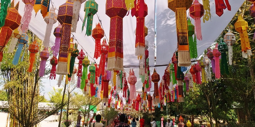Colorful temple entrance with ornate dragon sculptures and vibrant crowd scene
