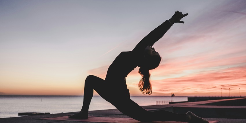 An image of a person practising yoga with a mesmerising backdrop in Indonesia.
