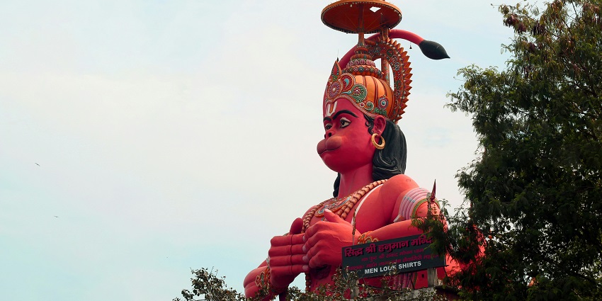 A large statue of Hanuman, echoing themes from Hanuman temples in Pune.
