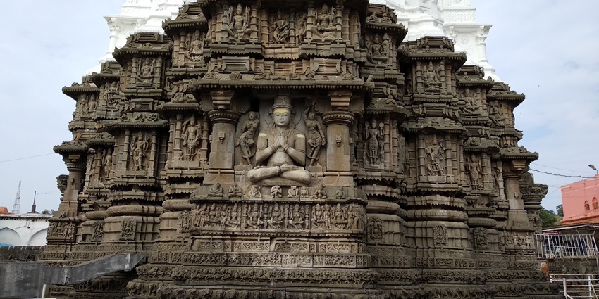 A frontal view of a temple with intricate carvings on its walls