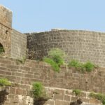 View of a bastion from the ground at Ausa Fort, showcasing its historic structure.