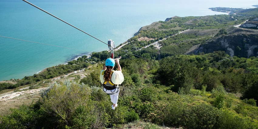 A woman ziplining, an exciting adventure camp featuring various adventures