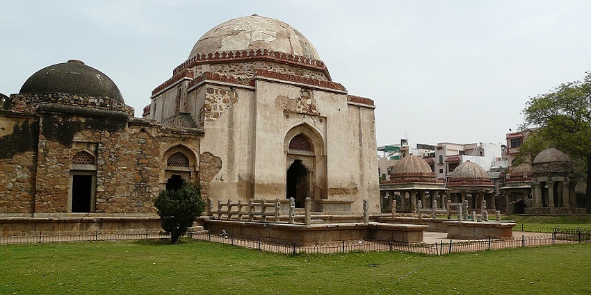 A picture of a tomb in Faridabad with a wide garden surrounding it