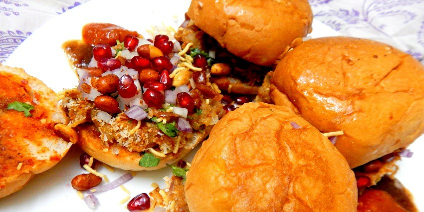 Dabeli is made from potato and tamarind pulp and garnished with onion and peanuts in buns.
