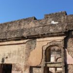 Ruins of Badshahpur Fort, showcasing historic architecture and stone walls.