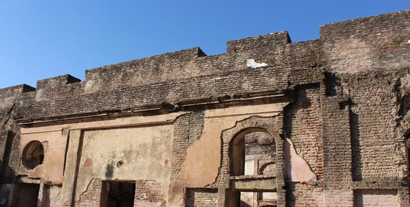 Ruins of Badshahpur Fort, showcasing historic architecture and stone walls.