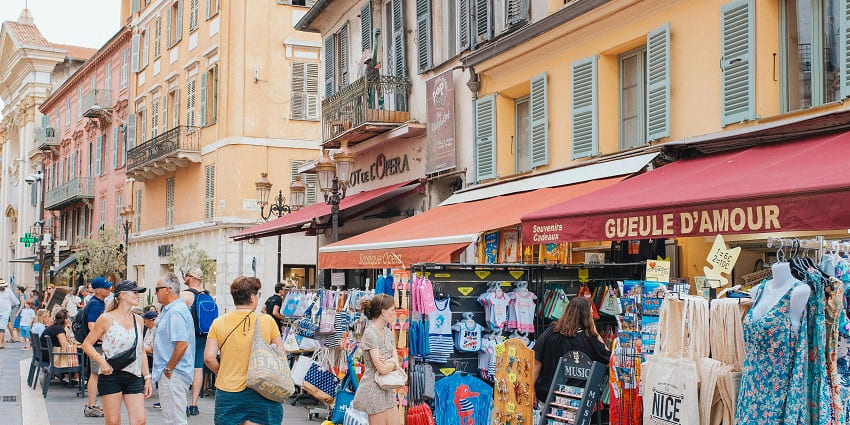 An image of Bali Collection's vibrant shopping area with shops and cultural performances.
