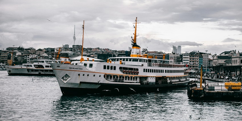 A view of a majestic ship sailing through the shimmering blue waters in the region.