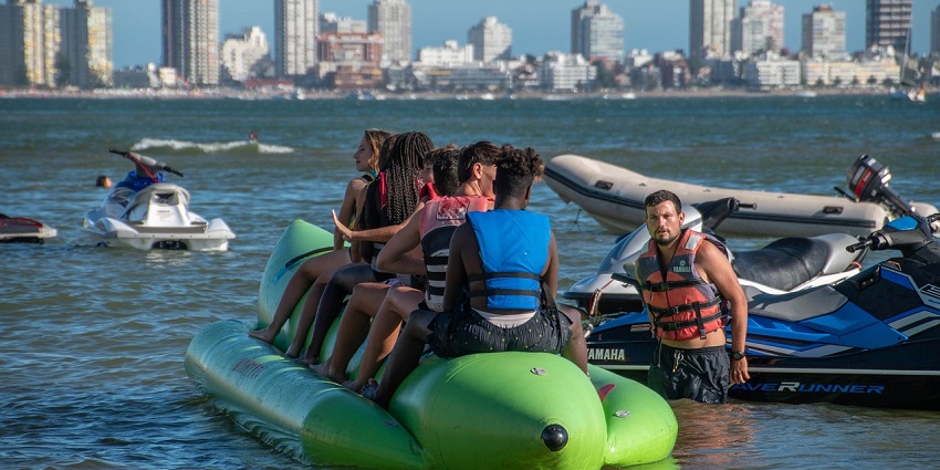 A picture of people enjoying a fun-filled banana boat ride at Murud Beach, Dapoli.