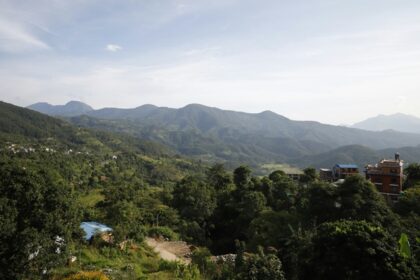 A bird’s eye view of the majestic peaks decked with lush green vegetation and trees.