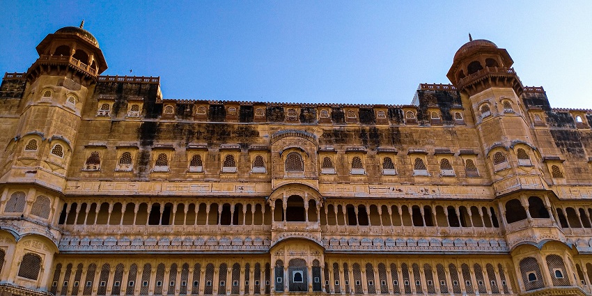 An outer view of a fort which has vibrant colours and contains numerous windows