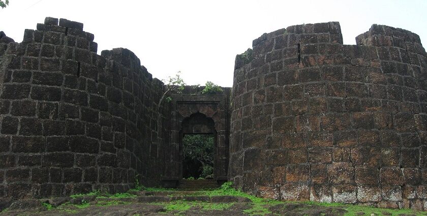 Panoramic view of Bankot Fort, highlighting its stone architecture and coastal surroundings.