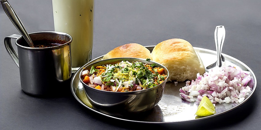 Misal Pav, a traditional snack of Maharashtra, served on a plate with chilled buttermilk.