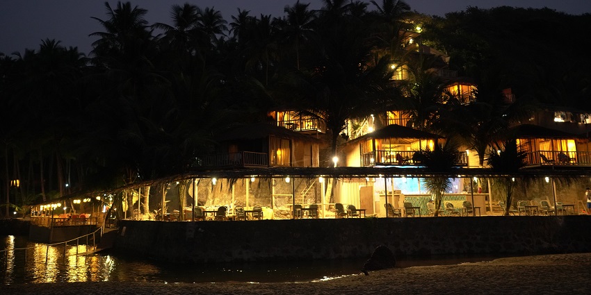 Image of a beautiful beach resort in South Goa surrounded by palm trees and lights