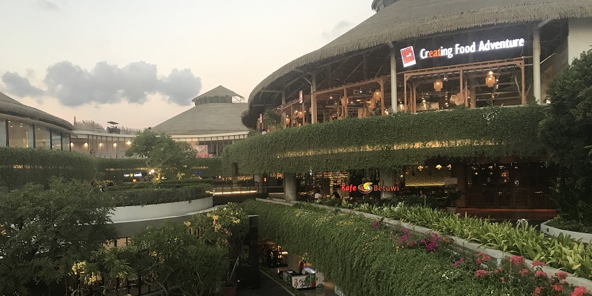 The open-air modern design of Beachwalk Shopping Centre in Bali covered with greenery, one of the top places to visit in Kuta.