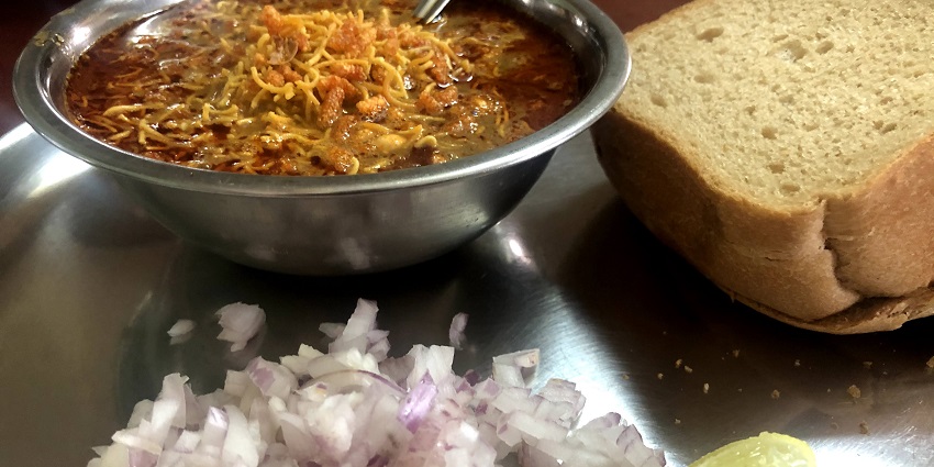 Spicy Kolhapuri misal served with two slices of bread - the best food in Pune.