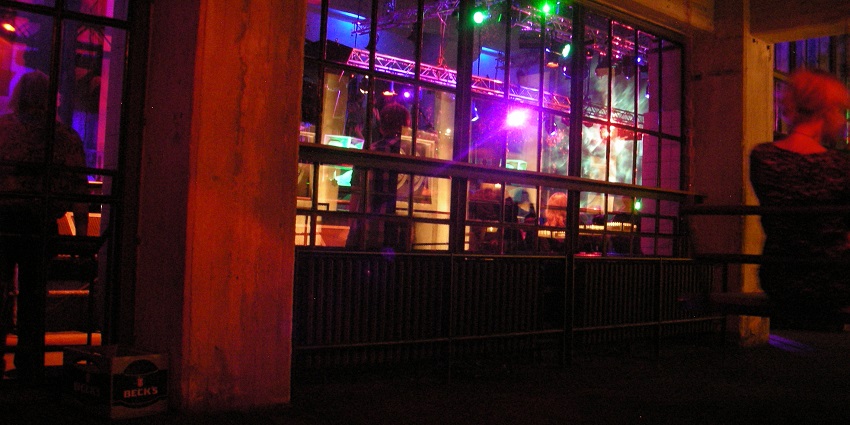 Party in Berlin at the iconic nightclub, known for techno music and intense atmosphere.