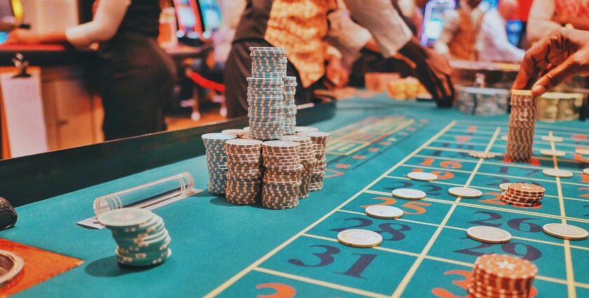 A glimpse of poker cards and tokens being displayed on a green table for playing.