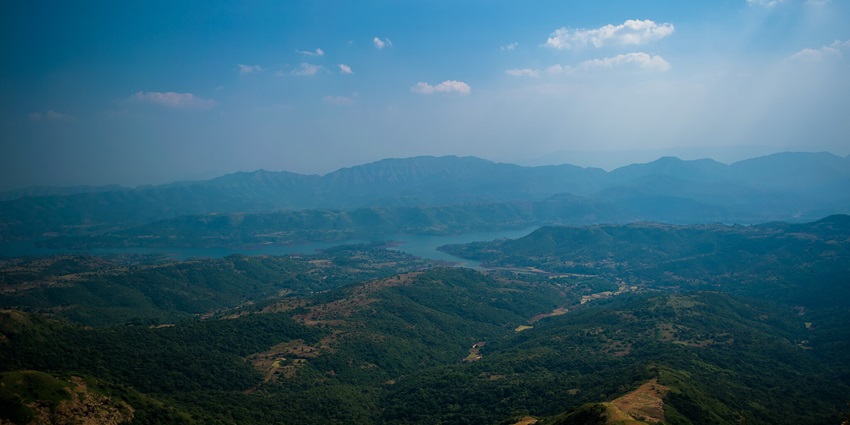 Maharashtra's valley during monsoon and mist with vibrant greenery.