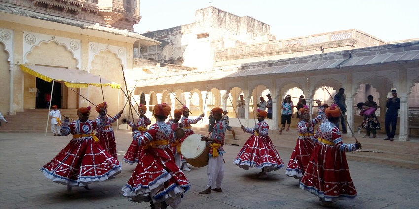 People are celebrating the folk festival inside a fort while wearing traditional outfits