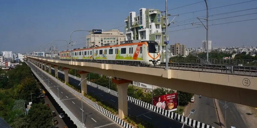 View of Nagpur Metro train passing through a busy urban area in Nagpur
