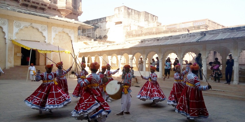 A folk festival being celebrated by the people in traditional outfits inside the fort
