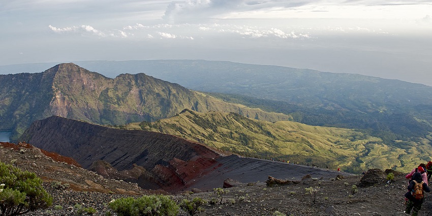 A picture of Mount Rinjani showing its changing landscape and a girl embracing it