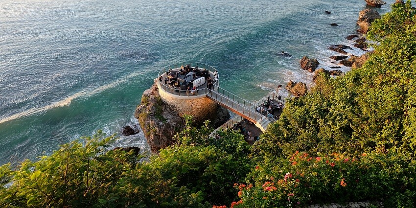 A scenic view of a group of pagodas sitting near Banyumala Twin Waterfalls.