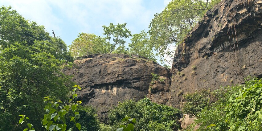 Interior view showcasing the impressive rock-cut sculptures in Kondana Caves.
