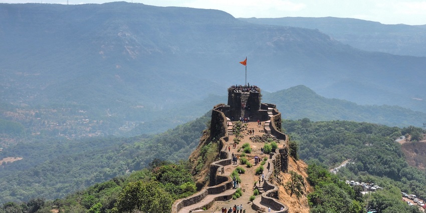 Discover the majestic fort, standing tall amidst lush green surroundings.