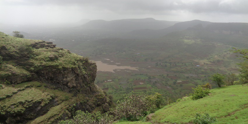 Cloudy weather over Anjaneri Hills in Nashik, with green landscapes and misty skies.