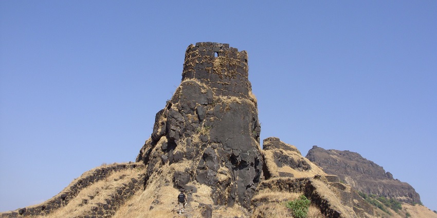Panoramic view of Shivaji Fort in Maharashtra, surrounded by lush greenery and mountains.