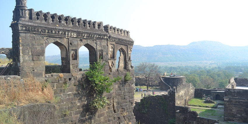 A significant wall of the fort against a bright blue sky, creating a dynamic view