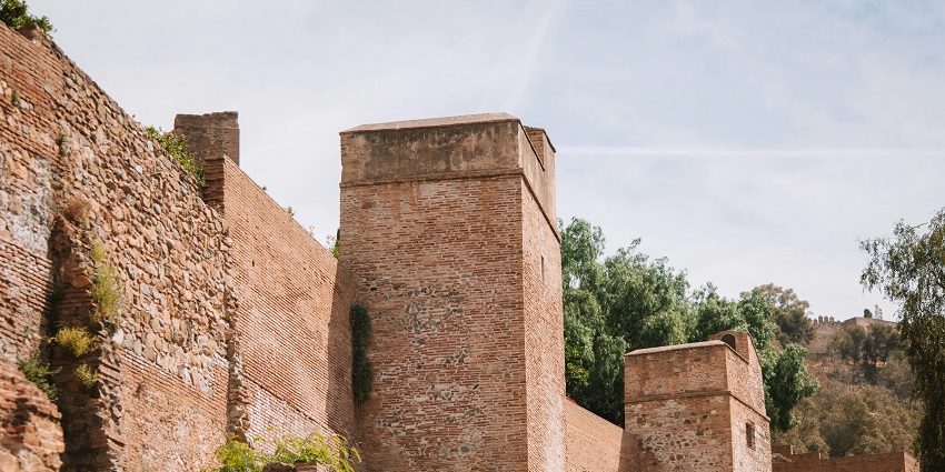 Majestic fortification walls and towers, a historic tourist attraction nearby.