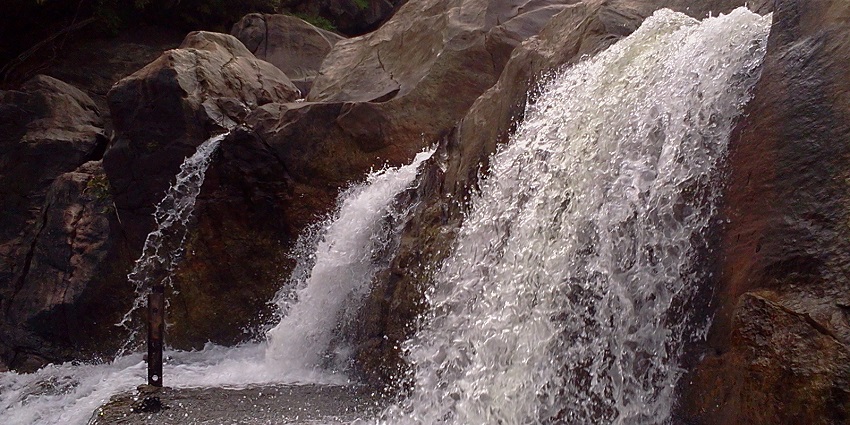 The picturesque view of Manimuthar Waterfalls at its peak during the monsoon.