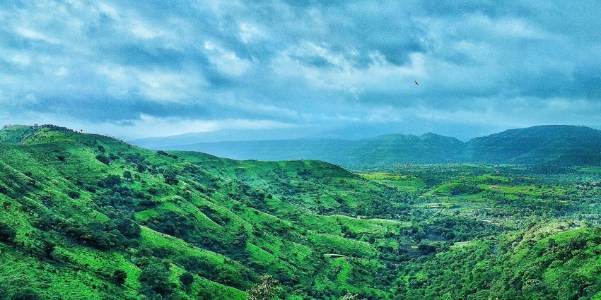 View of green landscape while climbing Torna Fort in Maharashtra, India.