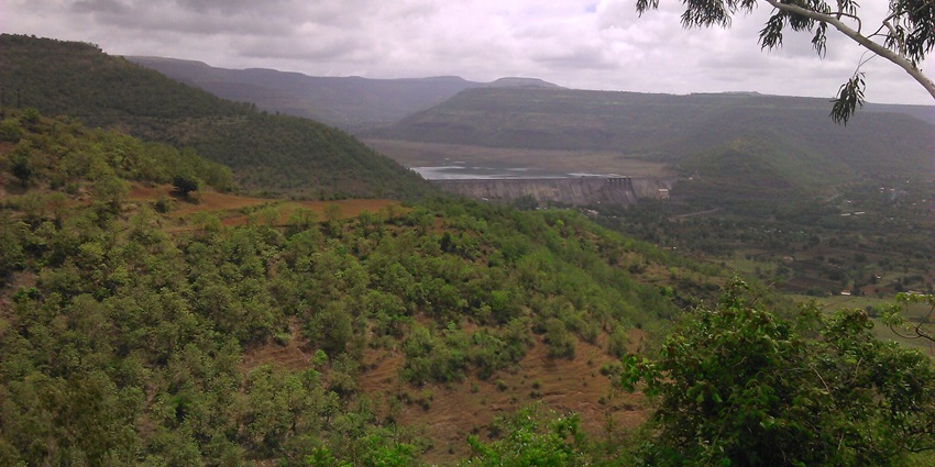 Picturesque view of Bhimashankar trek route surrounded by lush greenery under blue sky