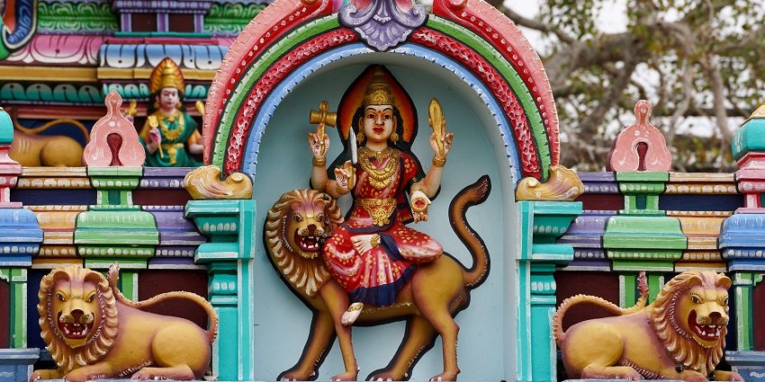 Image of Goddess idol in a temple with colourful decorations