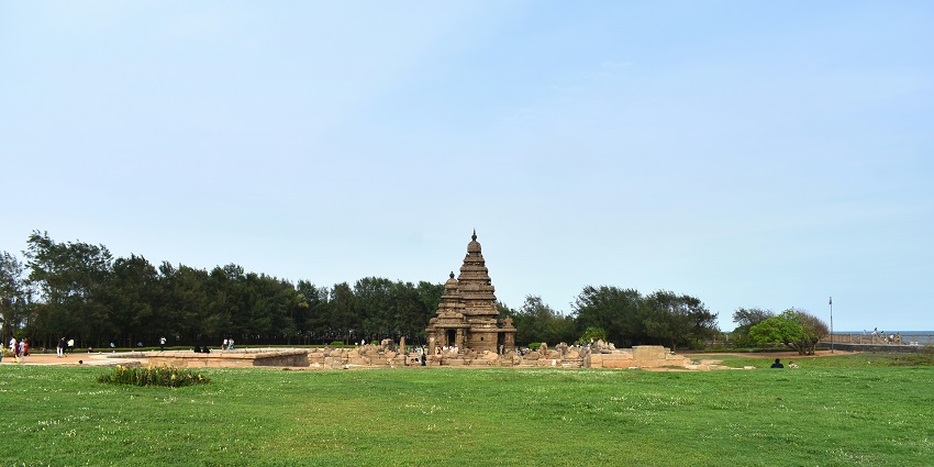 Shore Temple in Mahabalipuram with intricate carvings, standing against a clear blue sky.
