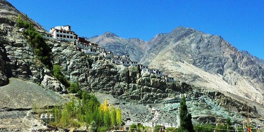 A picture of a worship place on top of a hill taken during daytime