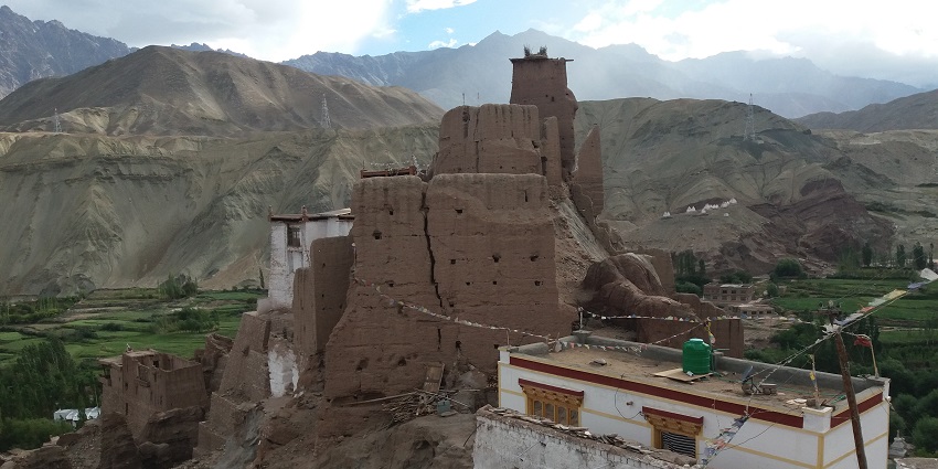 Image of Basgo monastery, Ladakh surrounded by rocky mountains under blue sky