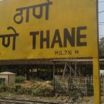 A shot of the yellow board at Thane railway station with name written in Hindi and English.