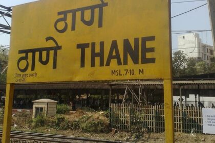 A shot of the yellow board at Thane railway station with name written in Hindi and English.