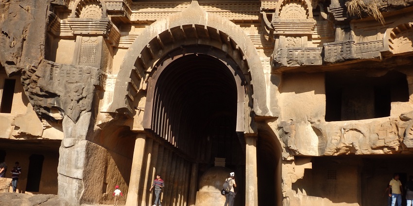 Ancient rock-cut caves in Bhaja, Maharashtra, showcasing intricate carvings.