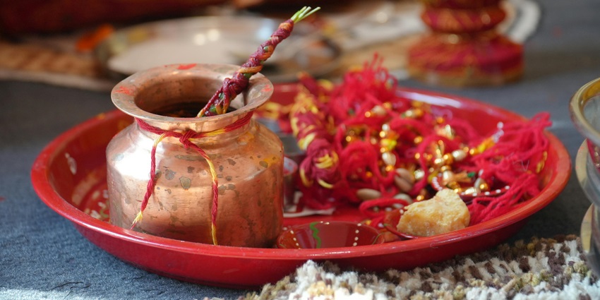 Image of a pooja thali decorated with flowers and other hindu ritual items